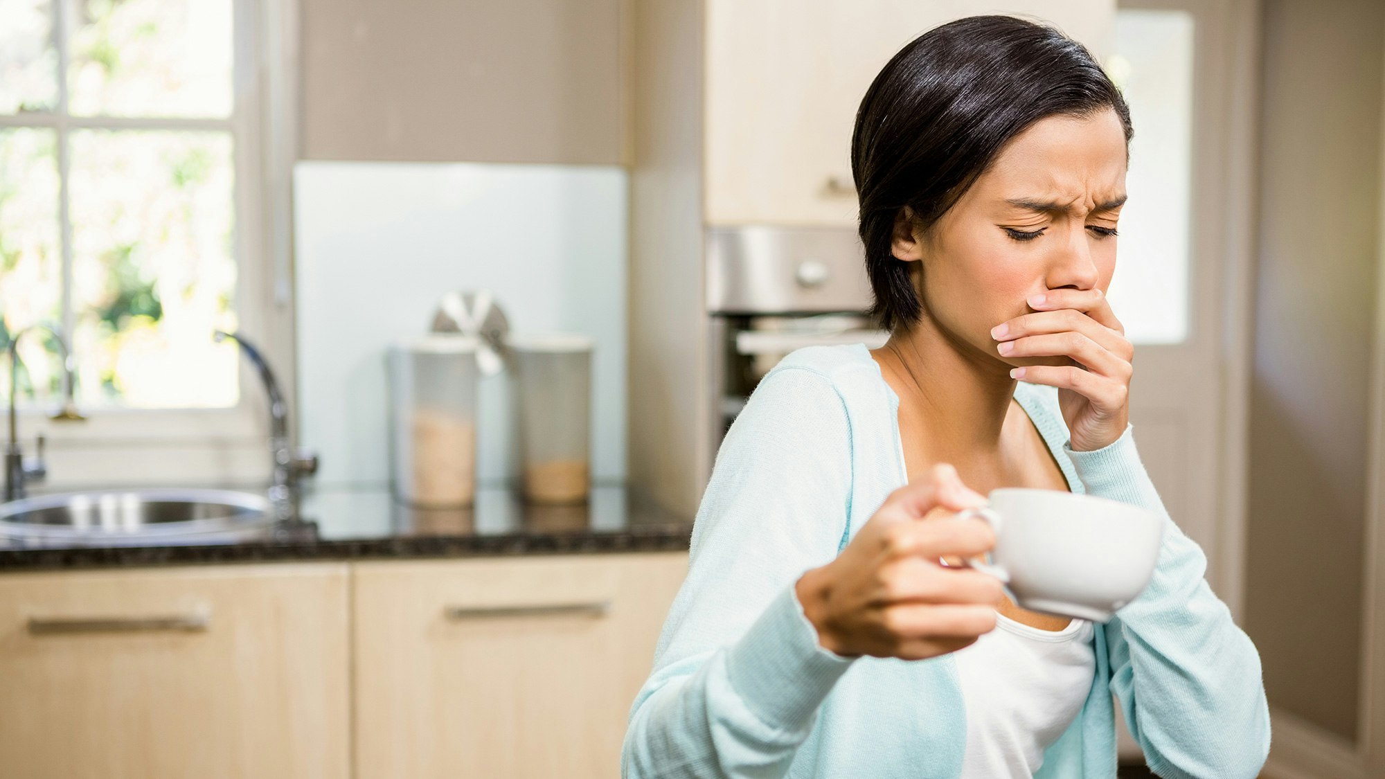 Woman covering her mouth