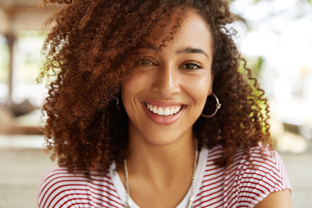 woman with curly hair and a nice smile