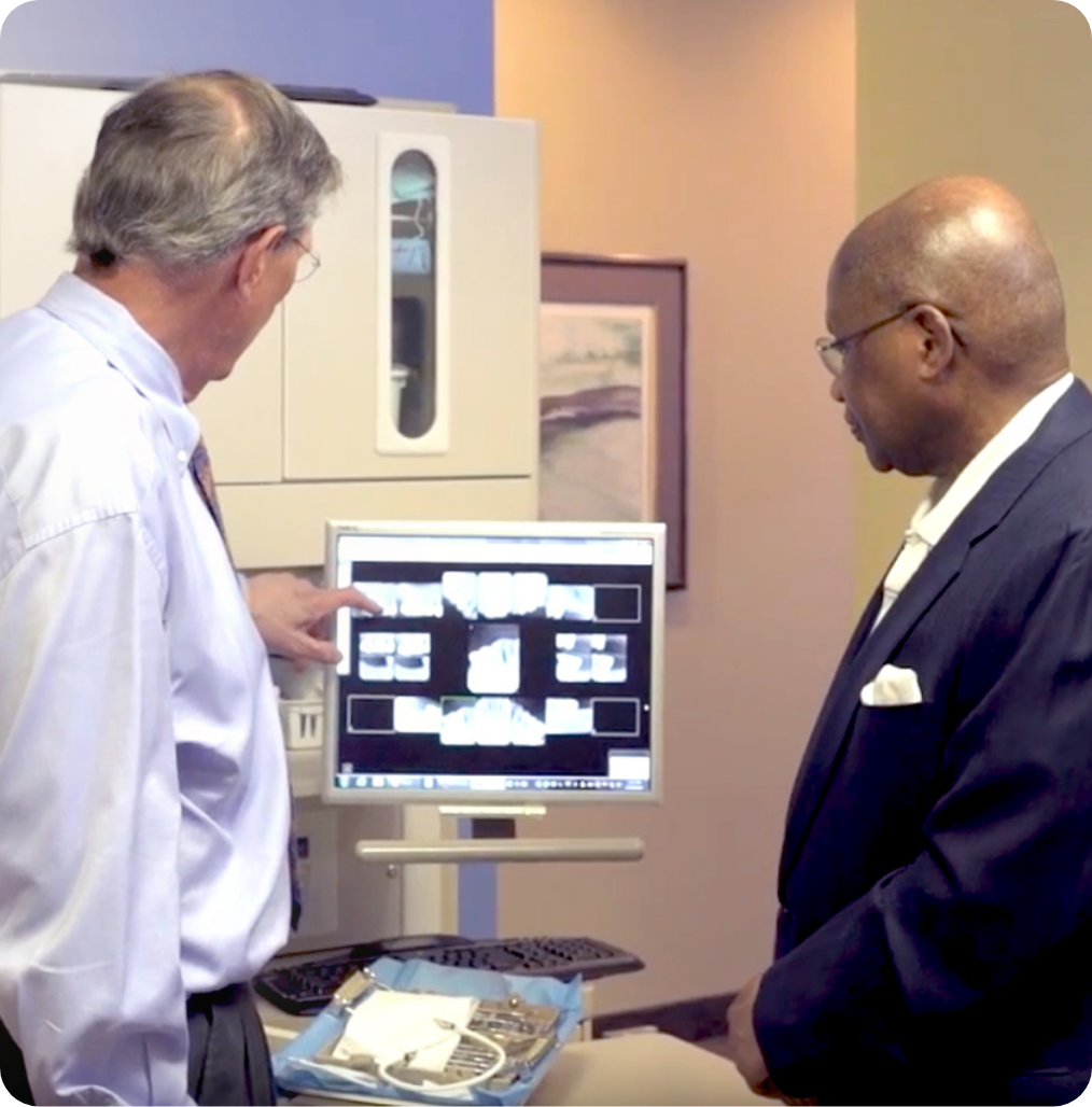 Dr. Withers reviewing dental X-rays with a patient in his Fairfax office