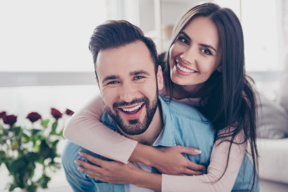 man and woman smiling