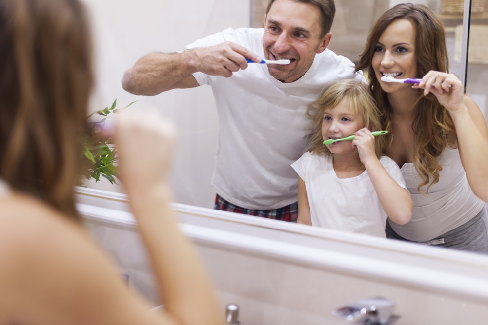 family brushing teeth