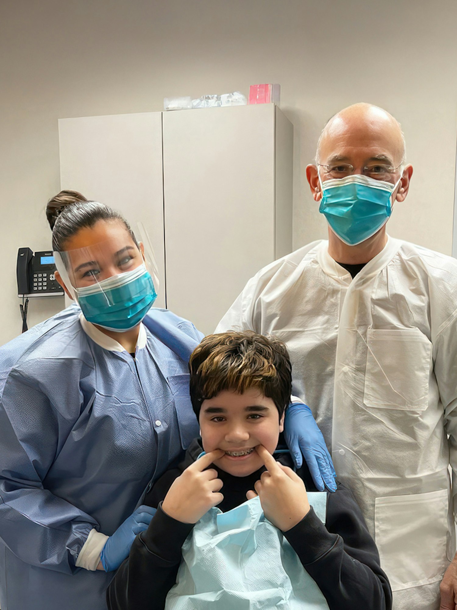 Happy patient with staff at the Exchange Dental Group