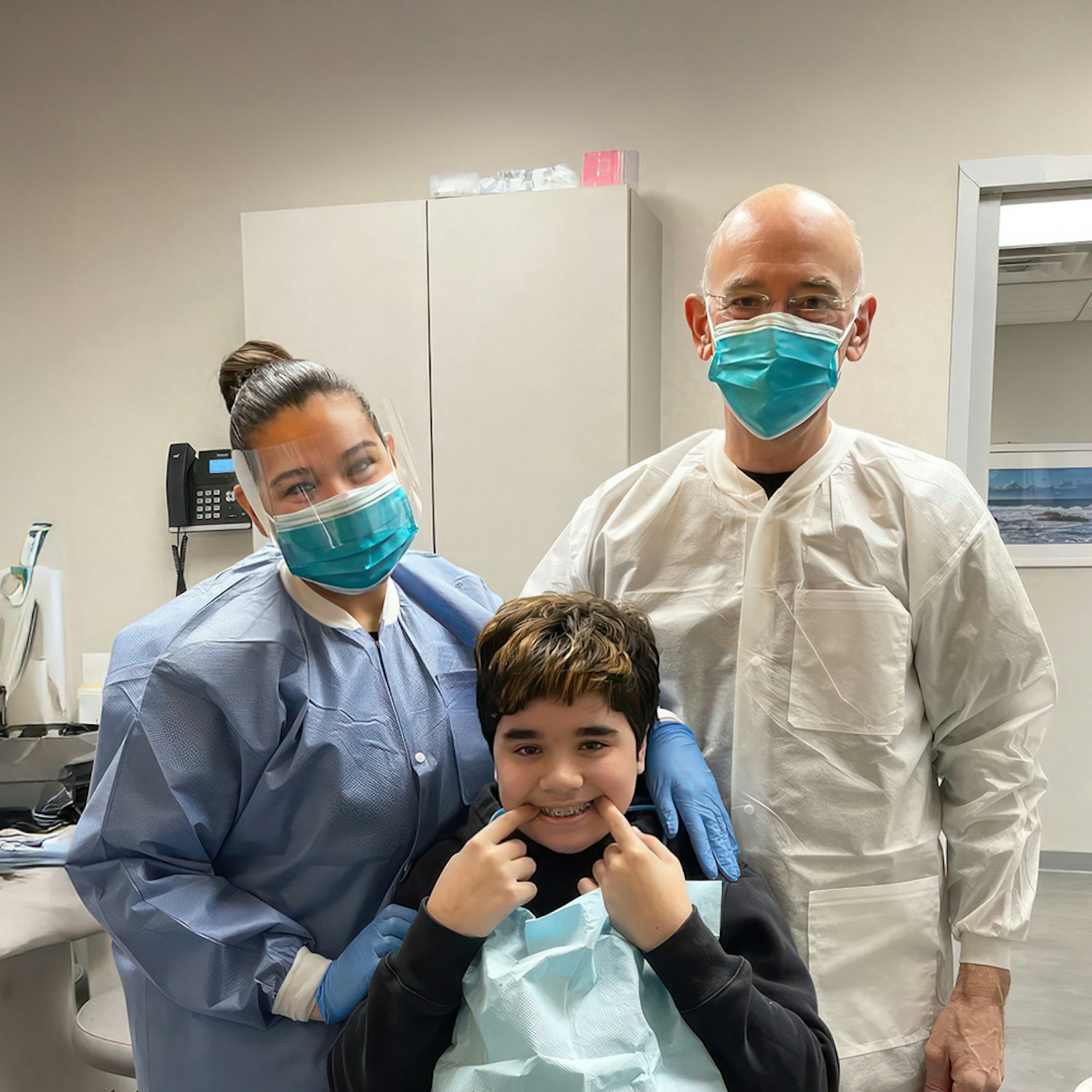 Happy patient with staff at the Exchange Dental Group