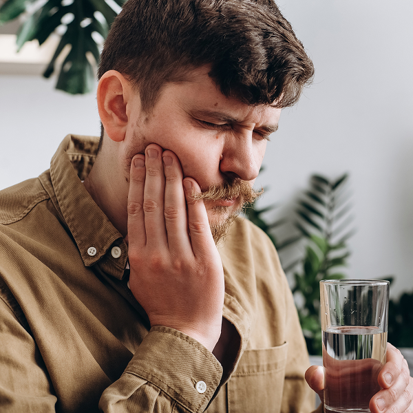 Man holding jaw in pain