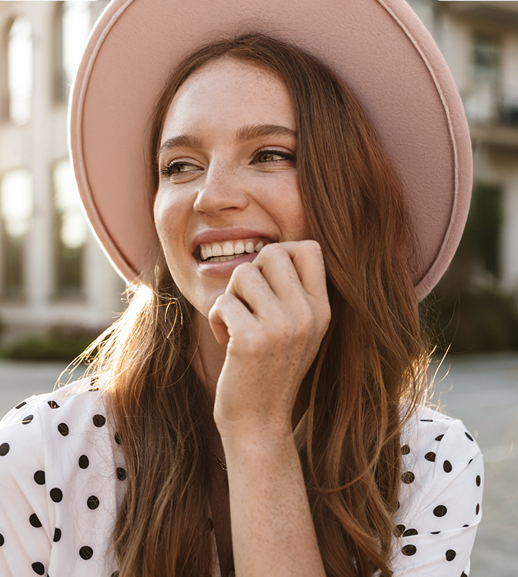 Smiling woman after help for a dental emergency