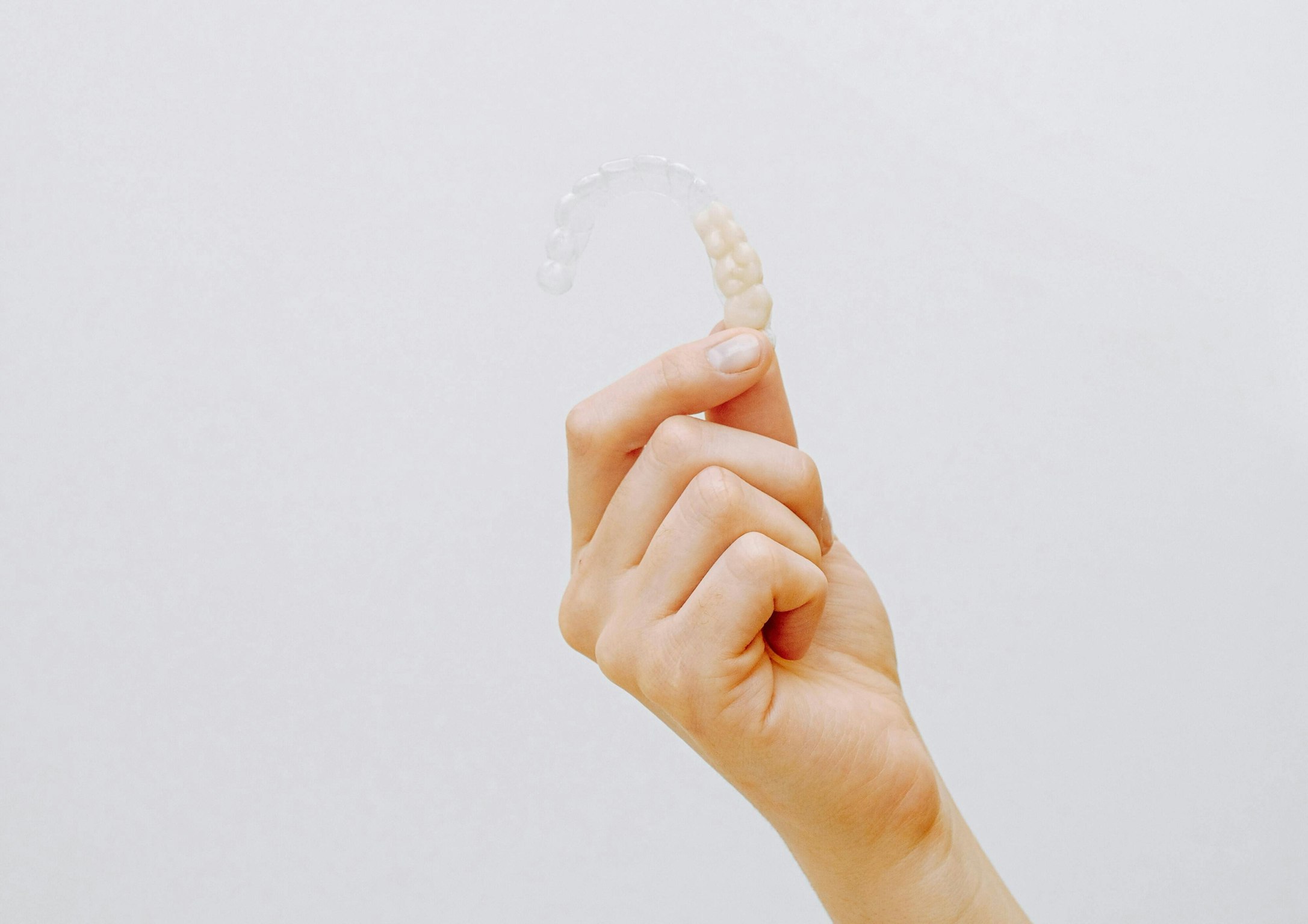 hand holding invisalign tray
