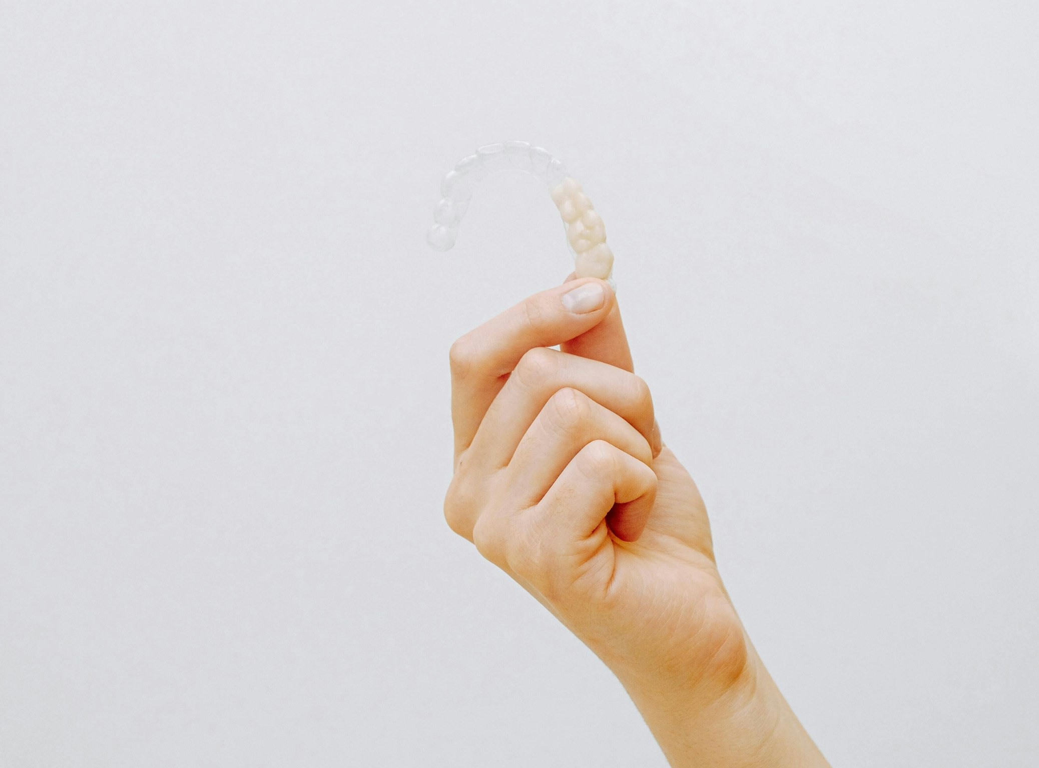 hand holding invisalign tray