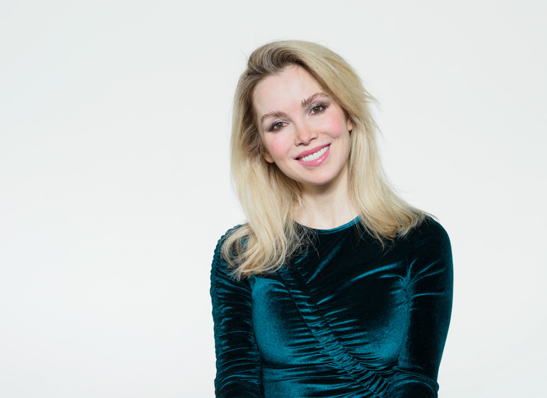 blonde woman with blue shirt smiling