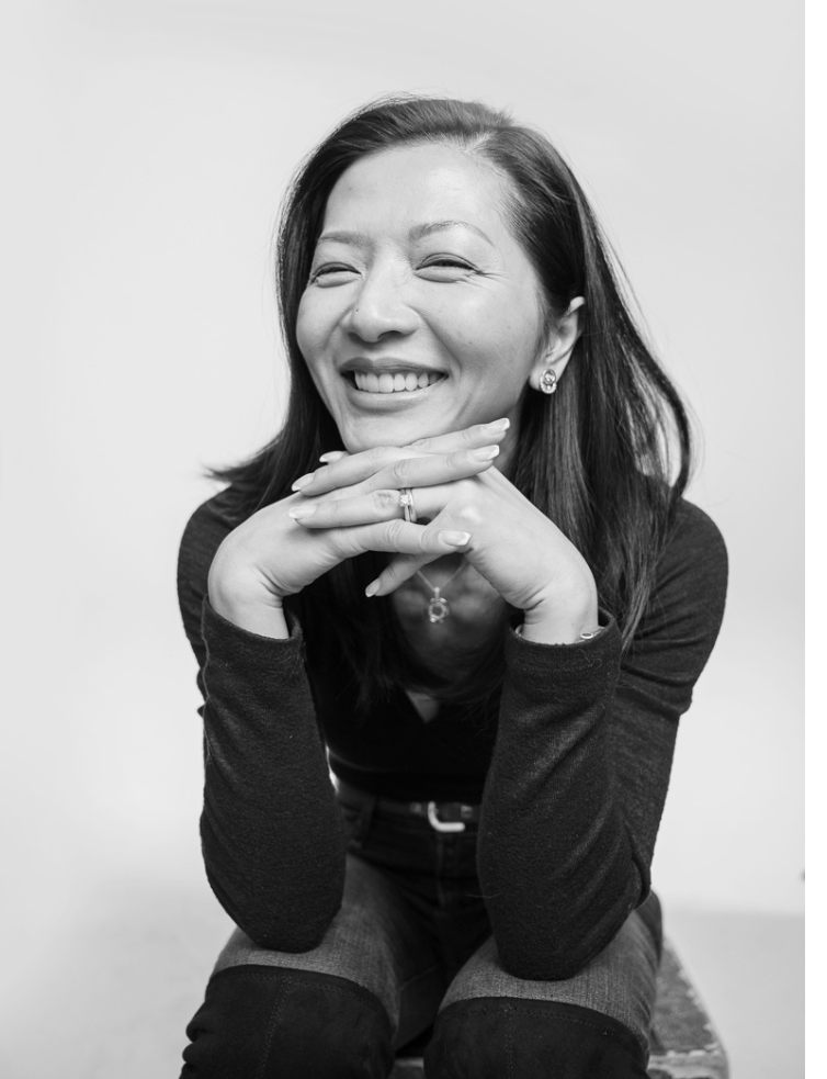 black and white image of a dark haired woman smiling