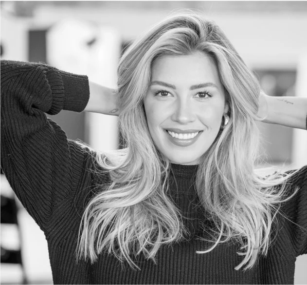 black and white photo of a blonde woman smiling