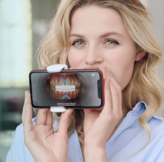 woman using portable dental monitoring app