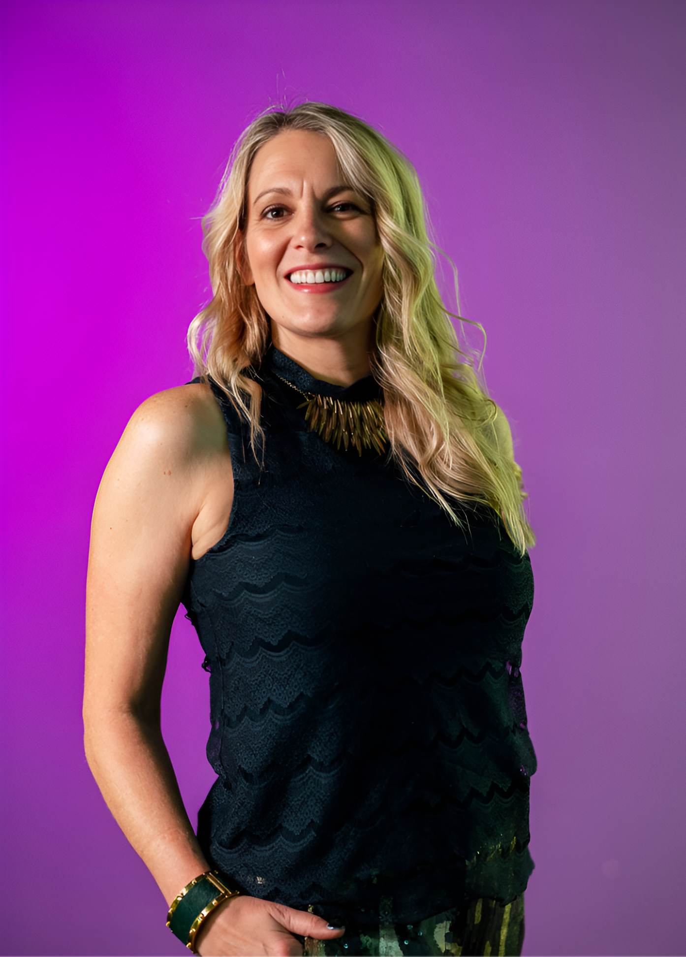 blonde woman posing against purple backdrop