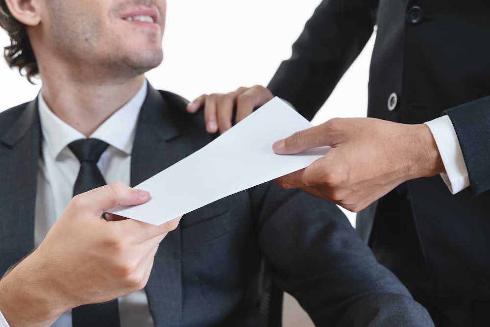 man getting handed a bonus check