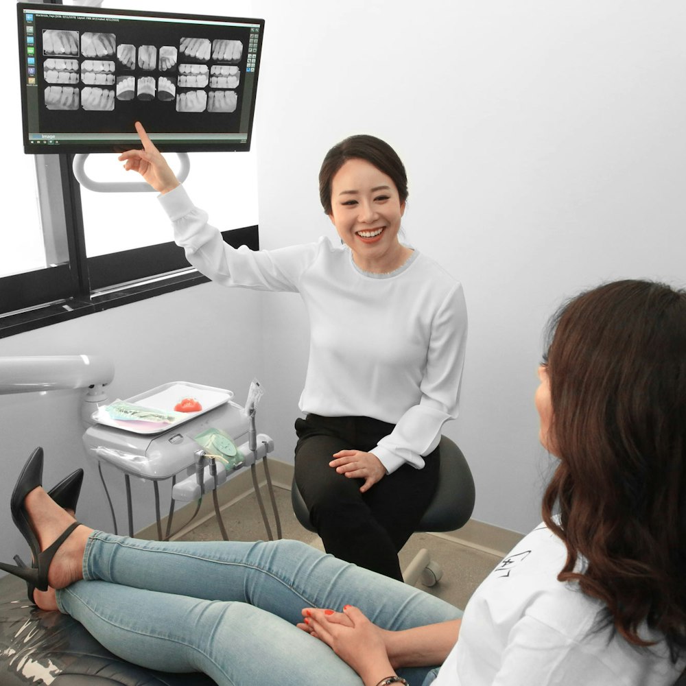 Dr. Oh showing scans to a patient