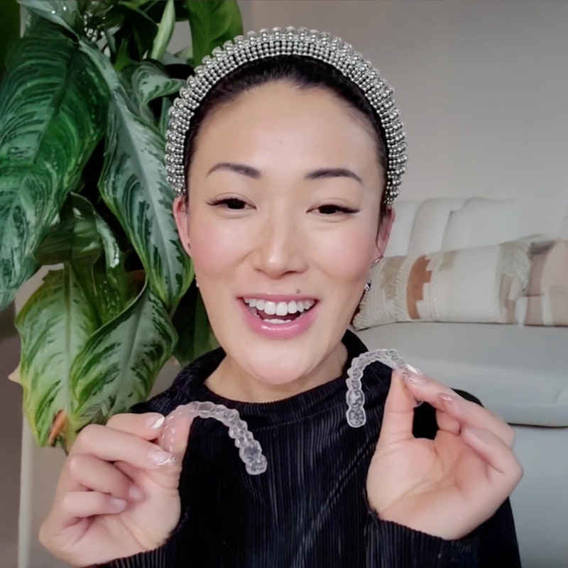 woman holding invisalign aligners