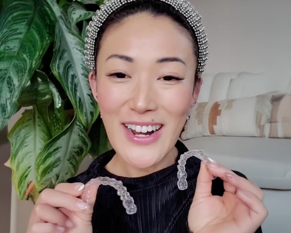 woman holding invisalign aligners