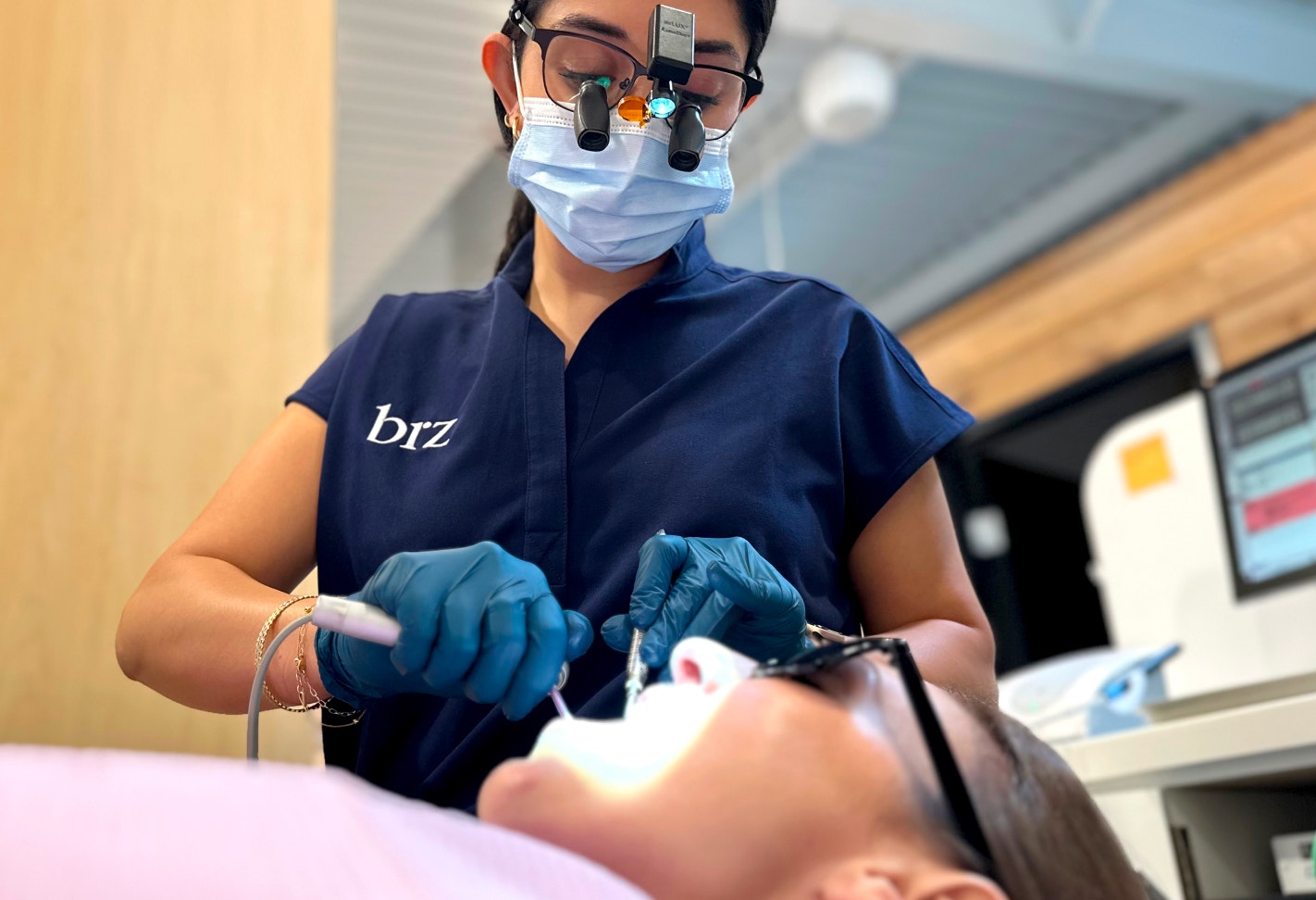 Hygienist cleaning patient