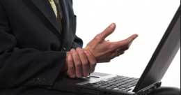 man holding wrist in pain