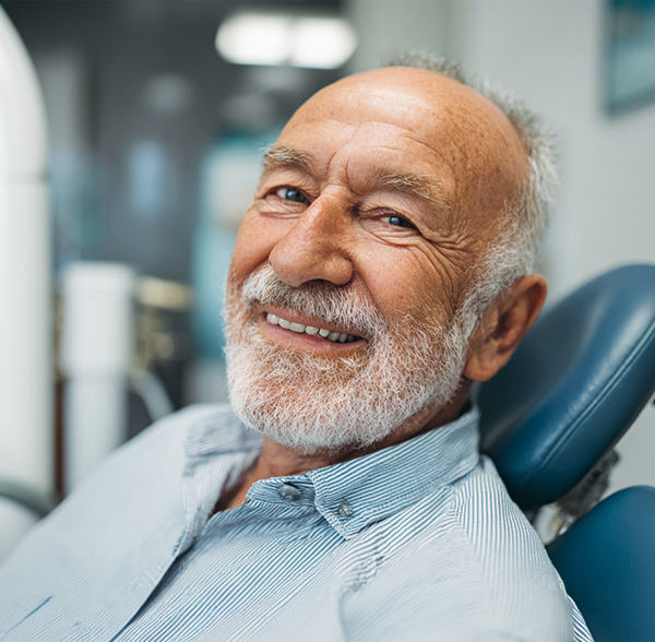smiling older man in dentist's chair