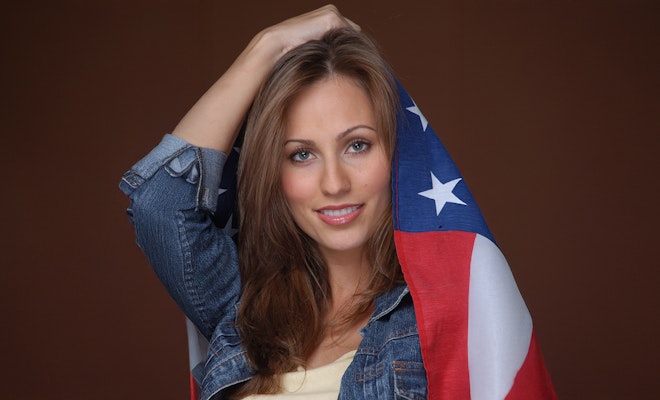 Woman with beautiful smile posing with American flag