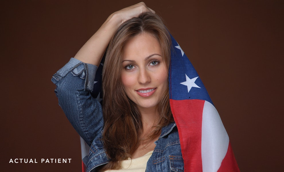 Woman with beautiful smile posing with American flag