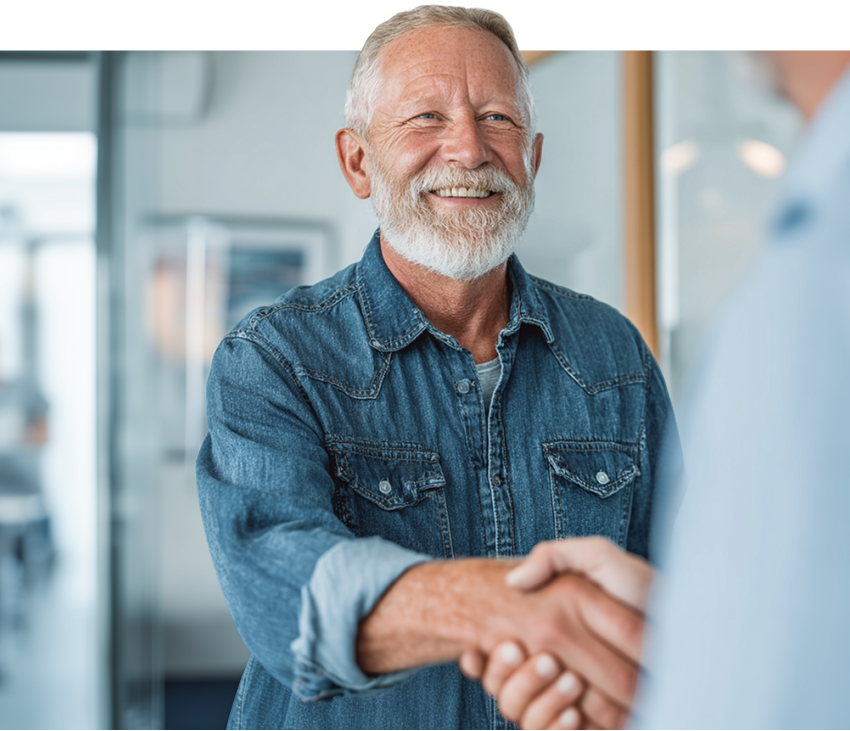 smiling man in denim shirt