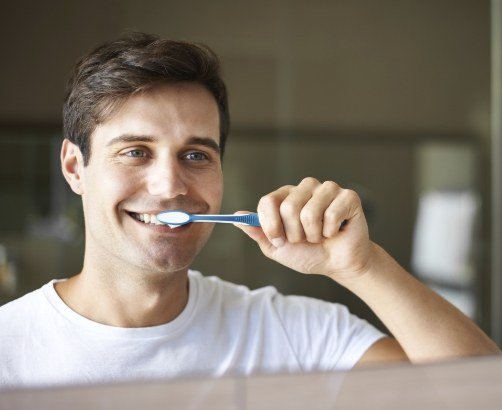 man brushing teeth