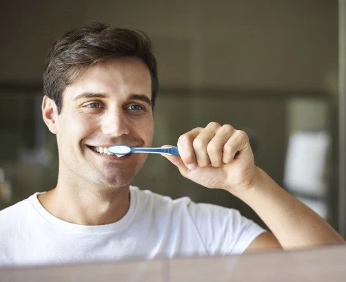 man brushing teeth