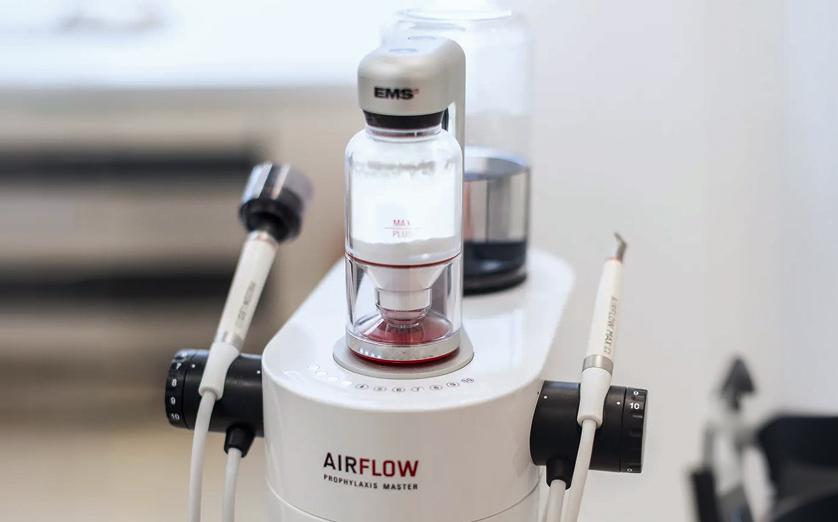 gloved hands holding oral appliance
