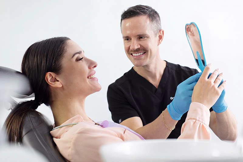 dental patient admiring her smile