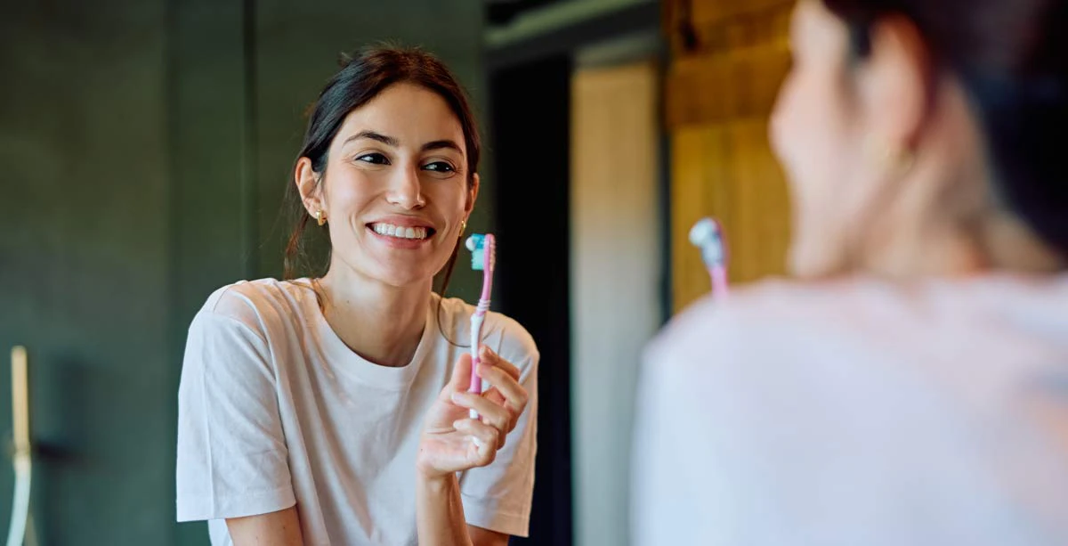 woman preparing to brush her teeth