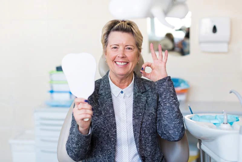 Woman smiling with her hand giving