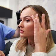 woman holding hands to face