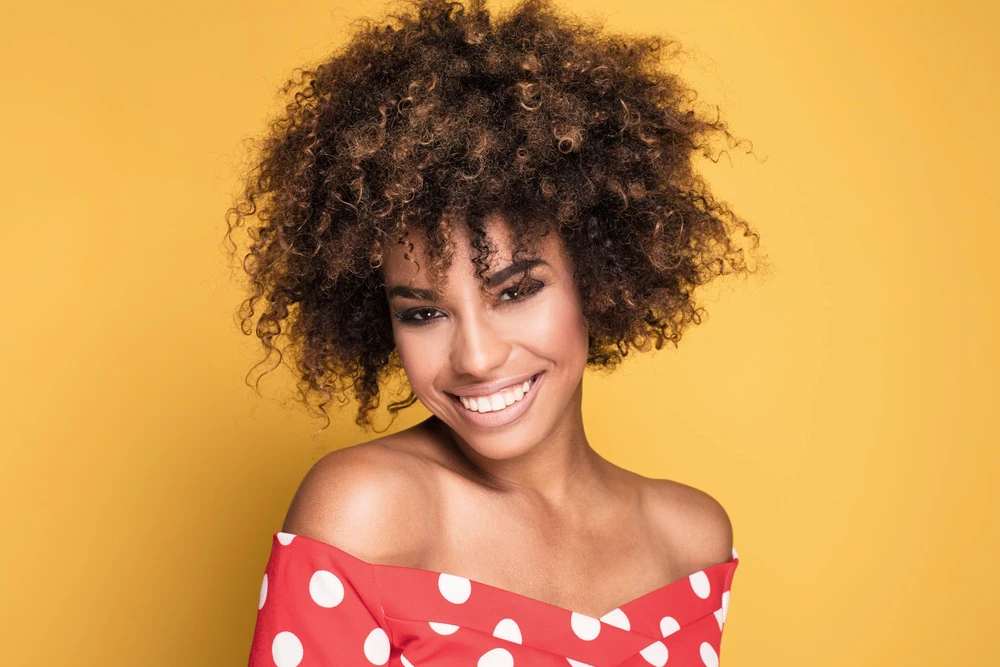 woman with curly hair smiling