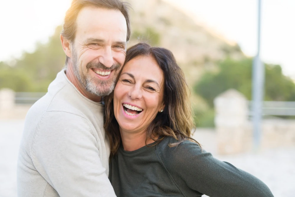 Couple smiling outside