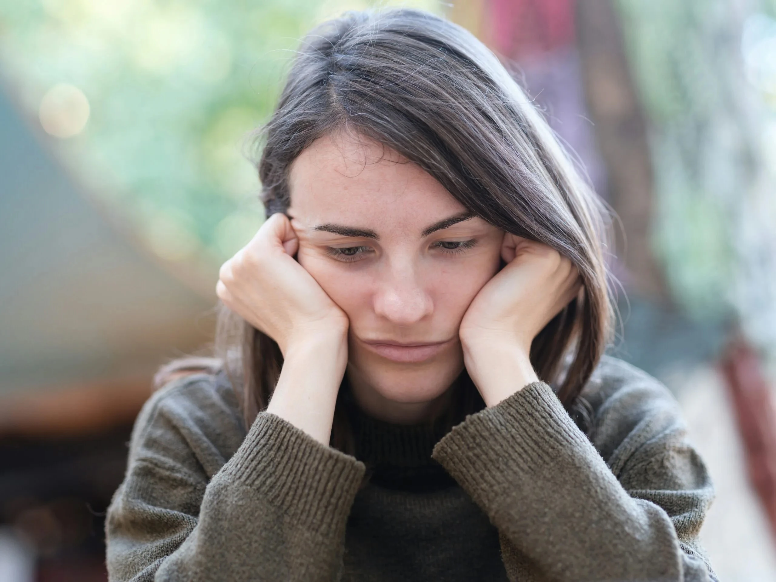 Upset woman holding face