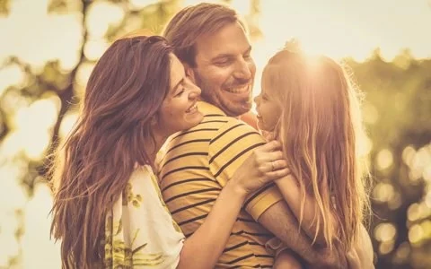 Happy family at sunset