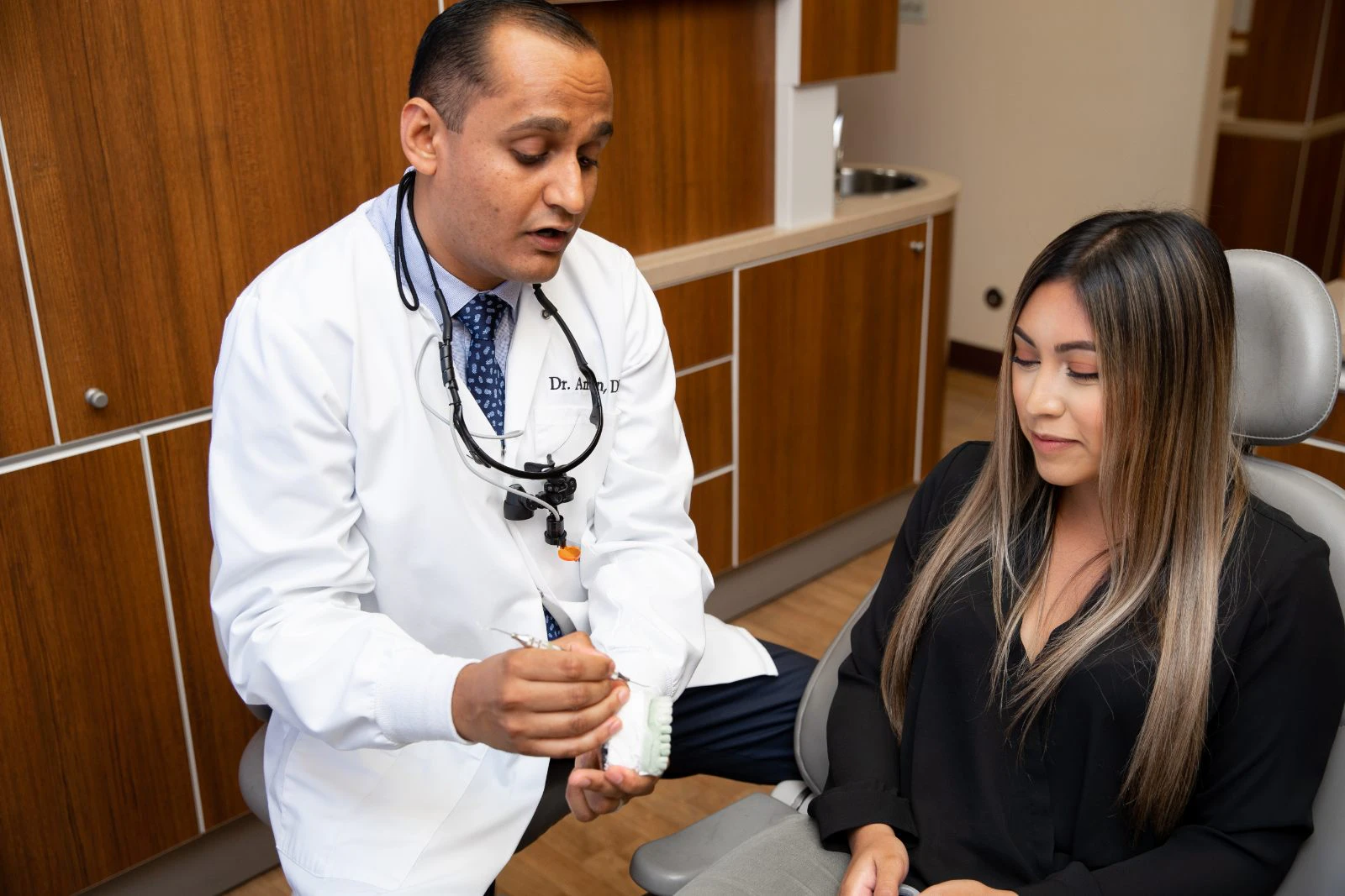 Doctor showing patient teeth whitening kit