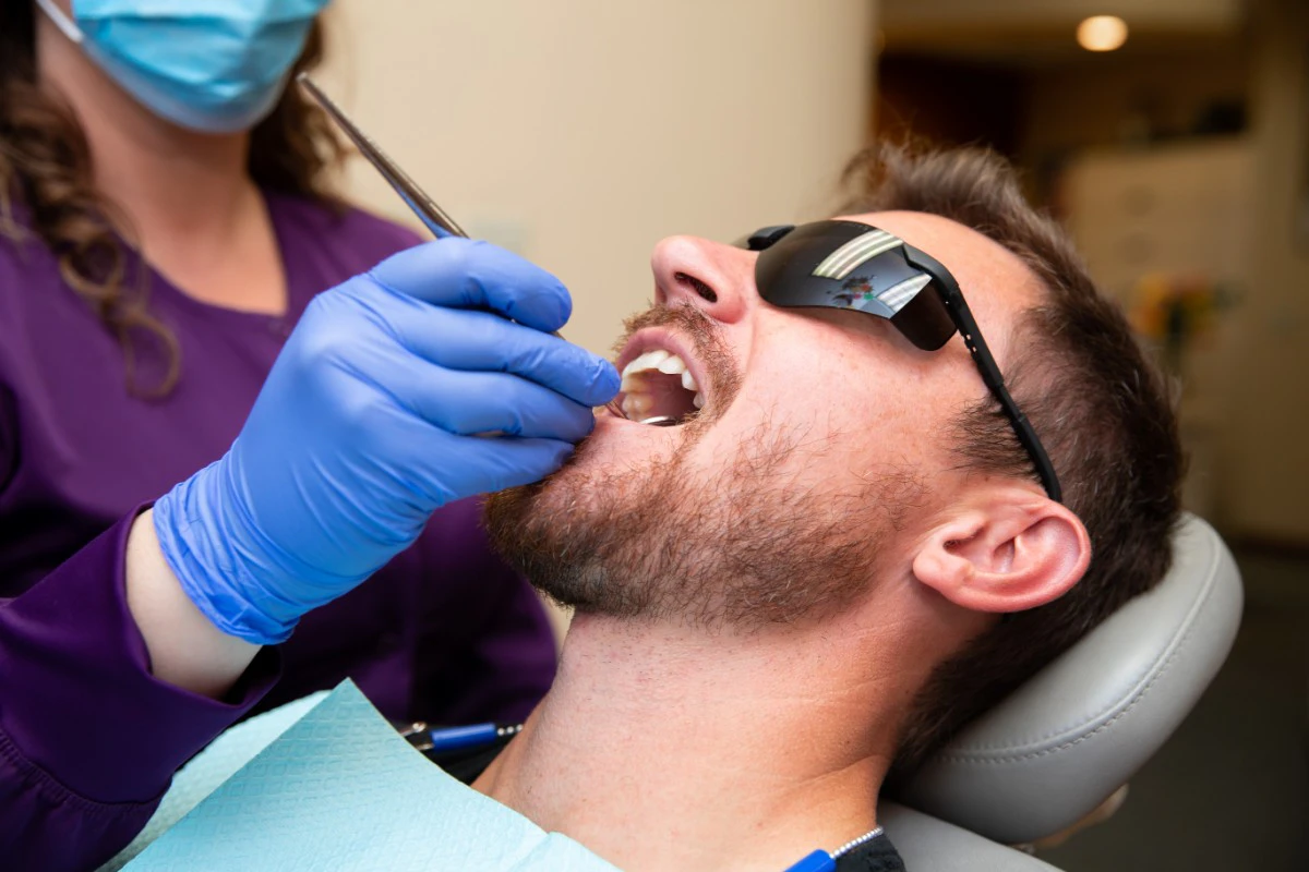 Dental hygienist cleaning patient