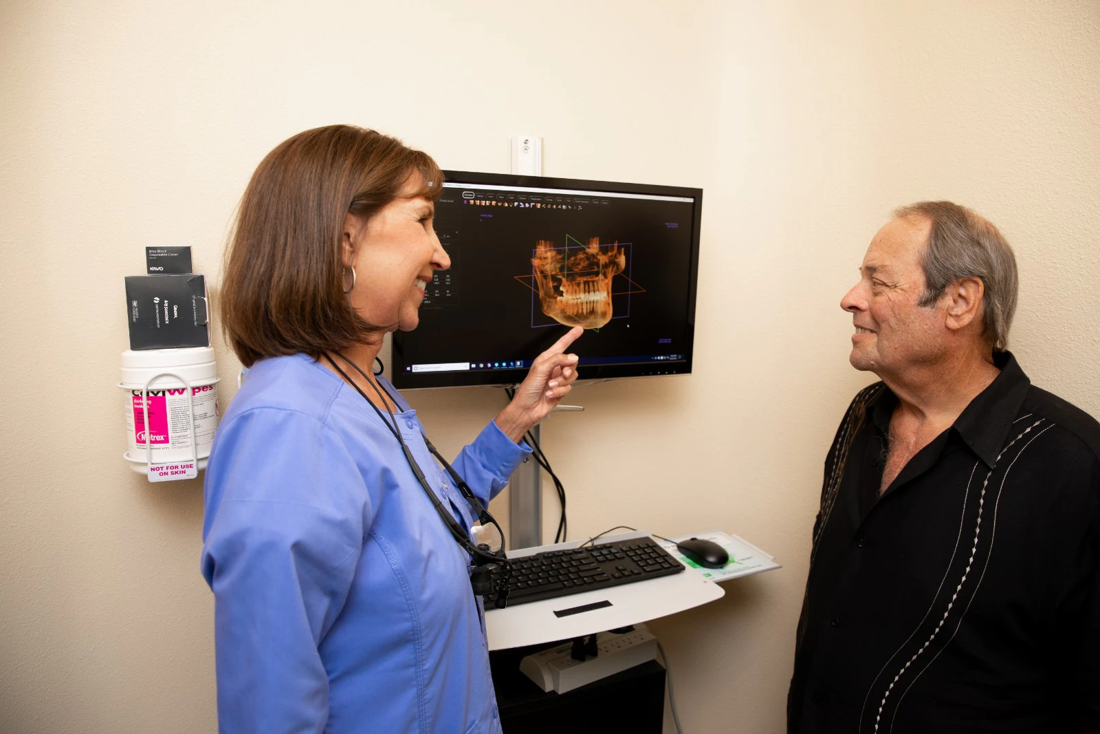 Staff going over CBCT x-rays with patient