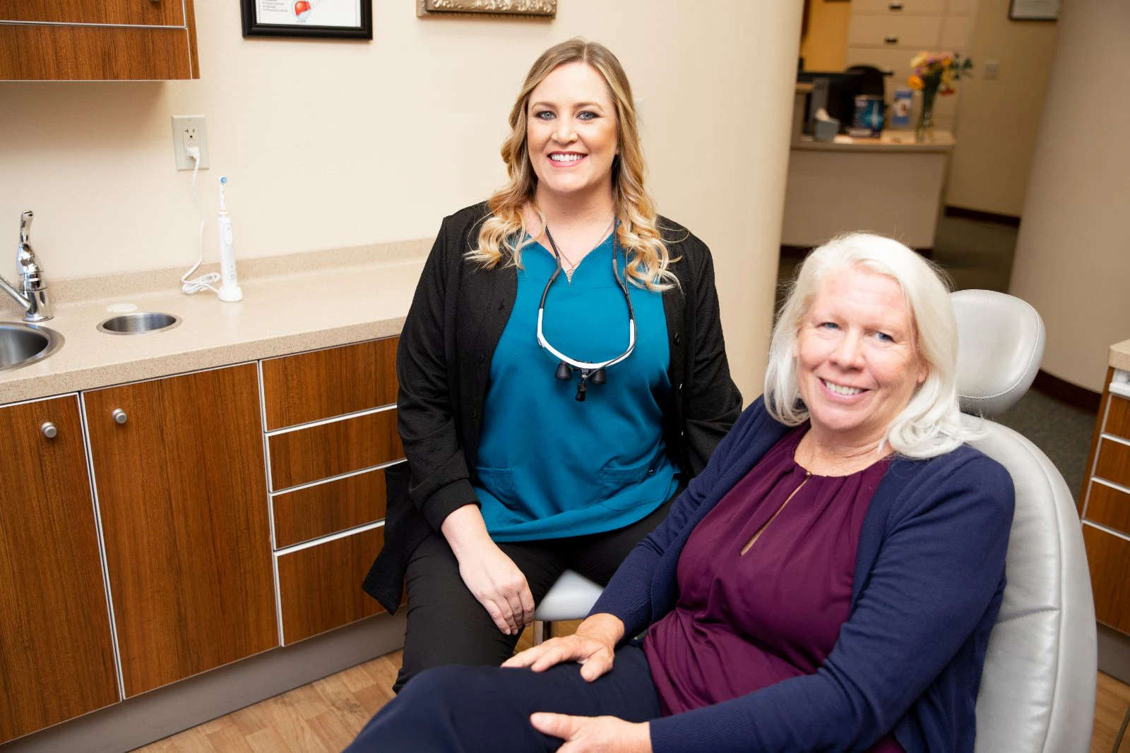 Dental hygienist with an older patient