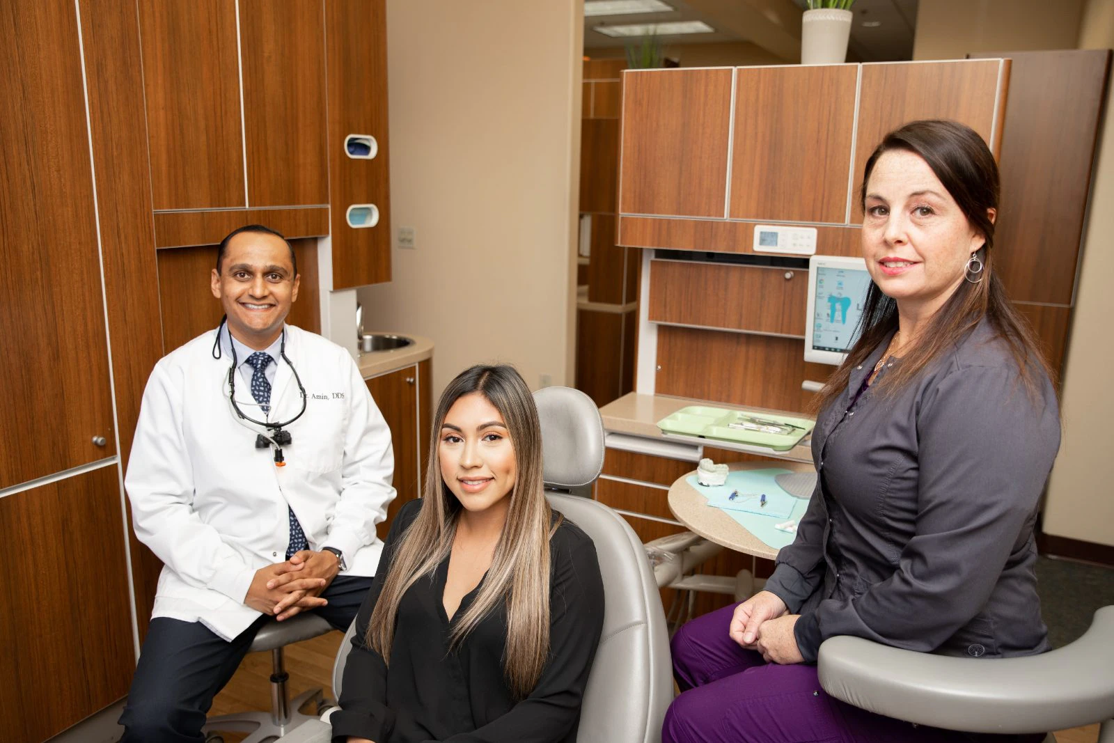 Doctor with patient and staff member