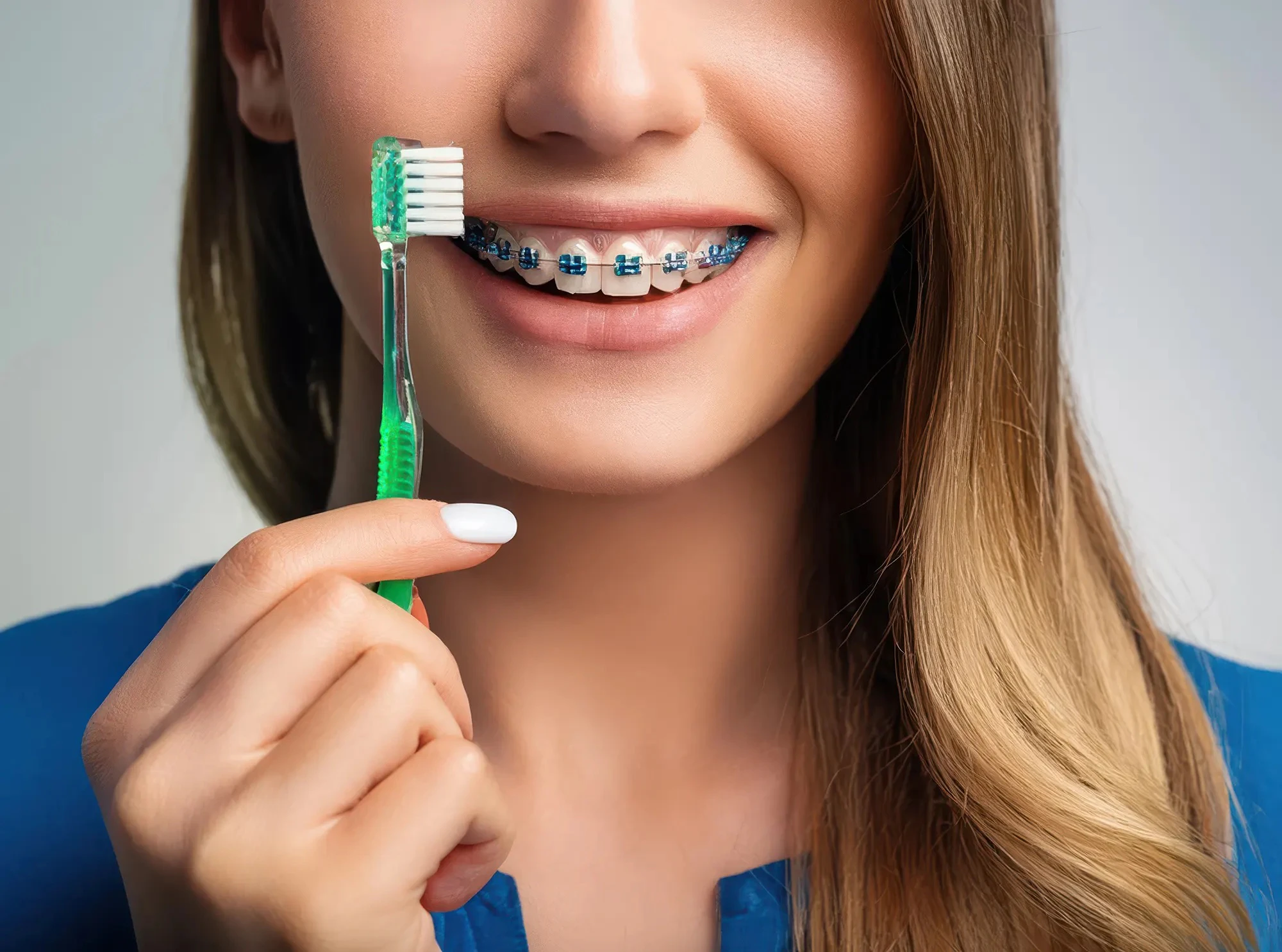 young blonde woman holding toothbrush