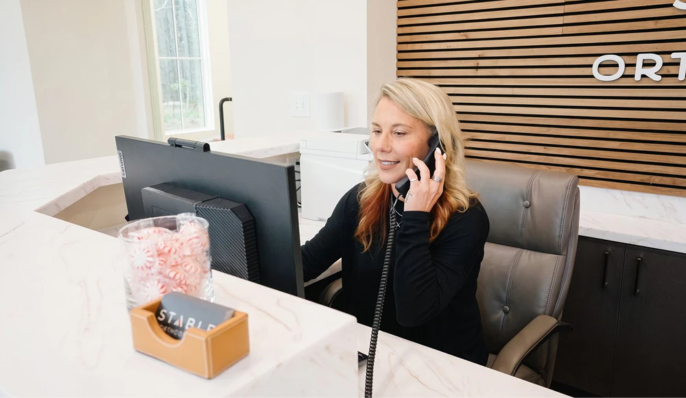Stable Orthodontics team member helping a patient on the phone
