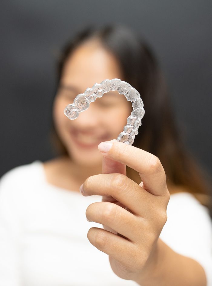 girl holding Invisalign tray