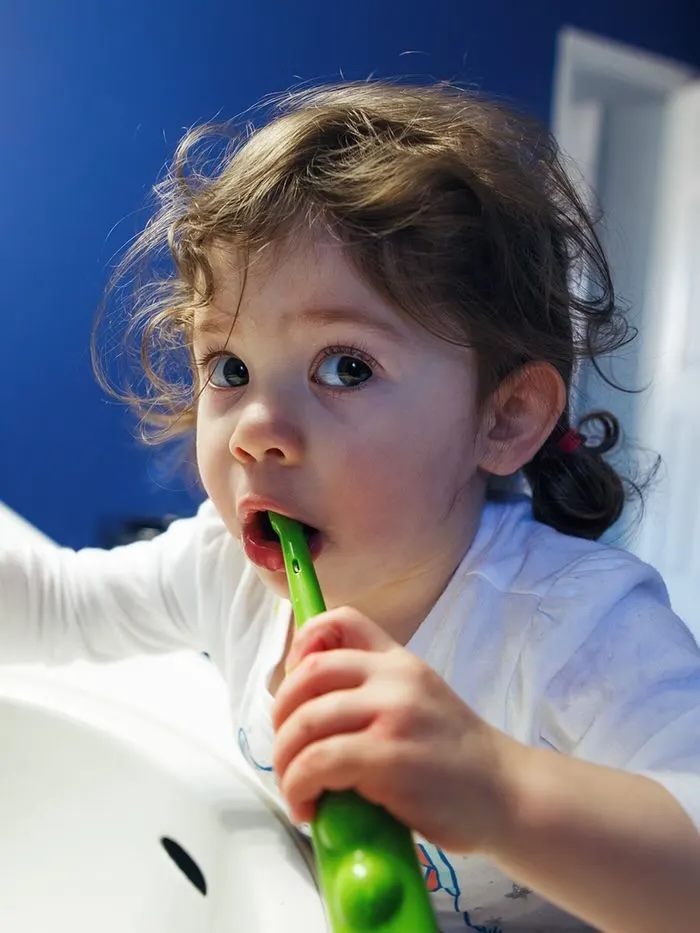 Toddler brushing their teeth