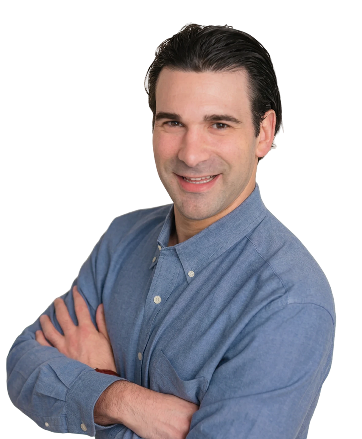 Dr. Kameron Tauber, pediatric dentist at Little Spurs, smiling with his arms crossed