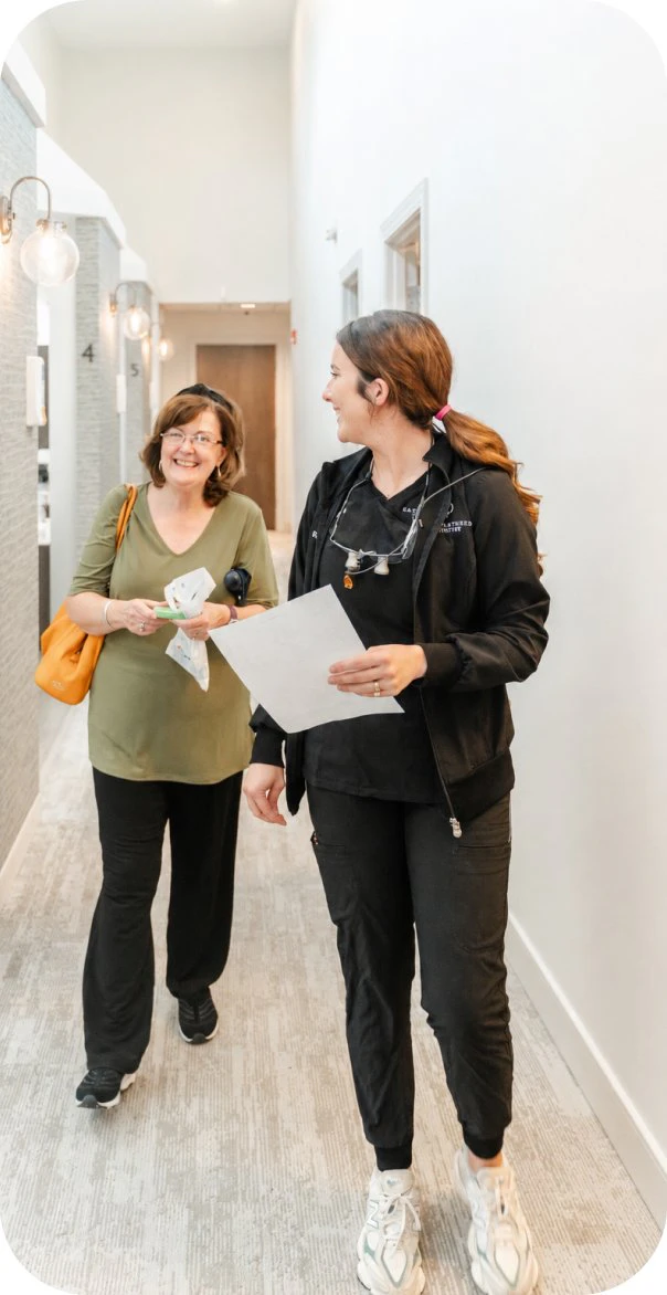 Team member walking a patient through the office