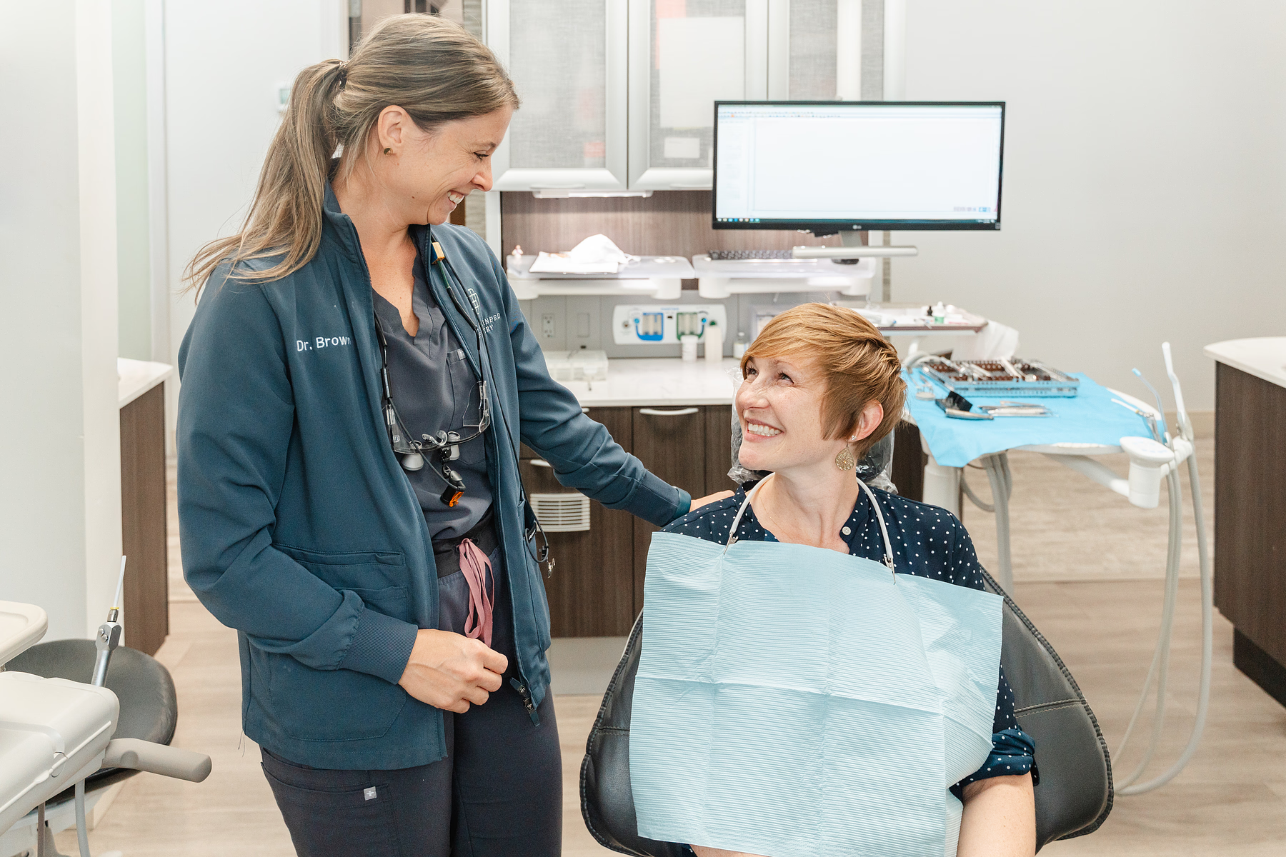 patient and hygienist smiling