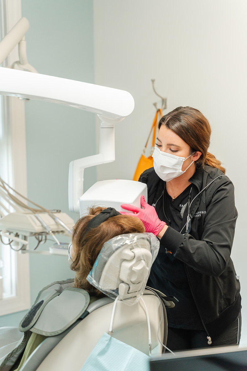 hygienist cleaning someone's teeth